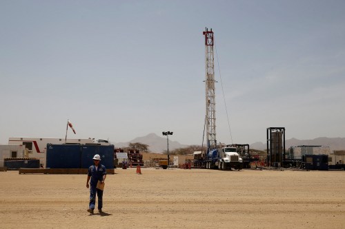 FILE PHOTO: A worker walks at a Tullow Oil explorational drilling site in Lokichar, Turkana County, Kenya, February 8, 2018. REUTERS/Baz Ratner/File Photo - RC1B8C49D650