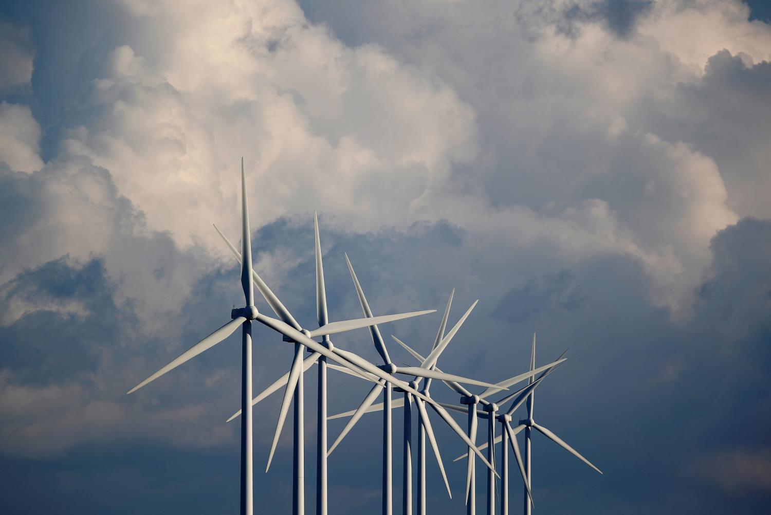 FILE PHOTO: Power-generating wind turbines are seen at a wind park near Greneville-en-Beauce, France, November 30, 2017. REUTERS/Christian Hartmann/File Photo - RC170168A5E0