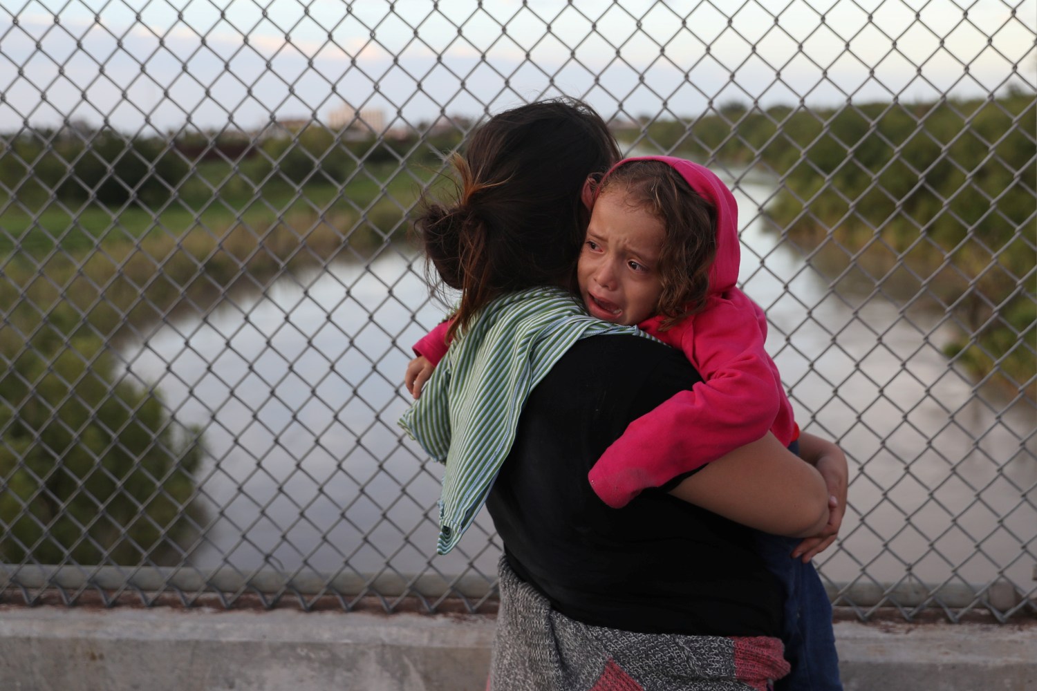 After being denied entry by U.S. Customs and Border Protection officers, an asylum seeking Honduran mother holds her crying 3-year-old daughter on the Mexican side of the Brownsville & Matamoros International Bridge near Brownsville, Texas, U.S., June 24, 2018. Picture taken June 24, 2018. REUTERS/Loren Elliott - RC1DAD0FC2D0