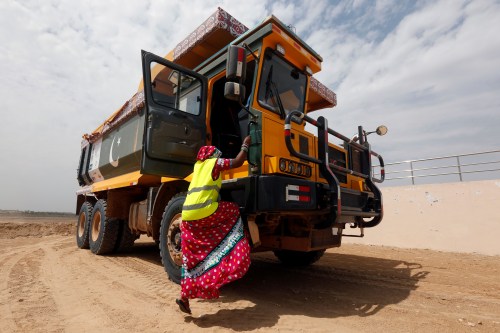 Gulaban, 25, mother of three, climbs into a 60-tonne truck, during a training session of the Female Dump Truck Driver Programme, held by the Sindh Engro Coal Mining Company (SECMC), in Islamkot, Tharparkar, Pakistan September 21, 2017. Picture taken September 21, 2017. REUTERS/Akhtar Soomro - RC14E23BF690