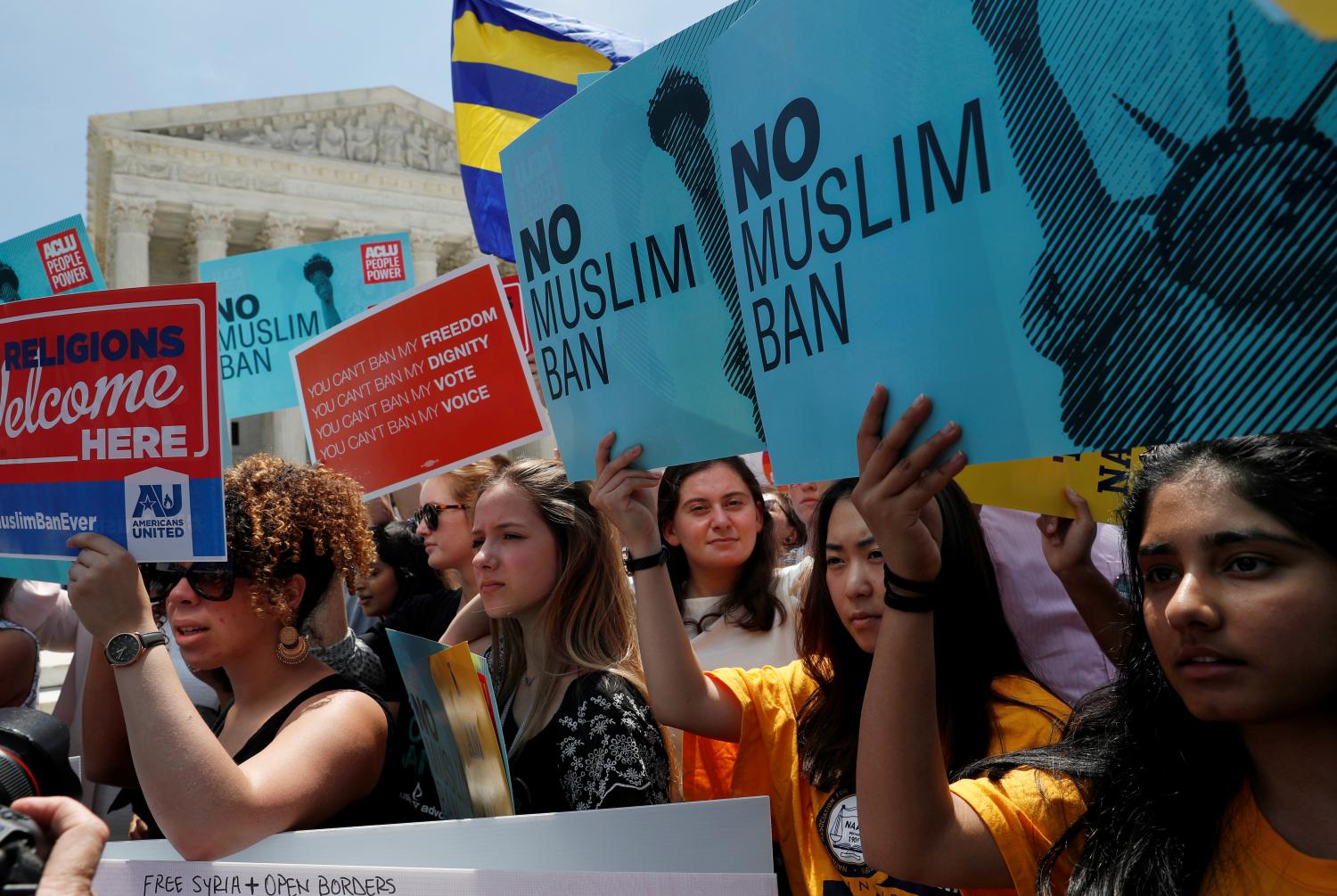 People protest outside of the U.S. Supreme Court after the U.S. President Trump's travel ban was upheld by the U.S. Supreme Court in Washington, U.S., June 26, 2018. REUTERS/Leah Millis - RC162FF29270