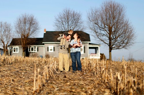 (L-R) Jeremiah Underhill is shown on the family property with son Dalton on his shoulders, wife and mother Annette, and baby Blake in her arms at their home in Richfield, Pennsylvania March 8, 2016. Picture taken March 8, 2016. To match Special Report USA-WATER/LEAD REUTERS/Gary Cameron - WASEC381SER01