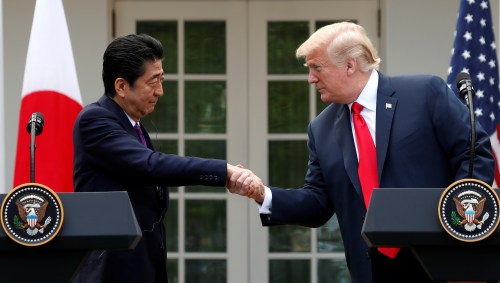 U.S. President Donald Trump greets Japan's Prime Minister Shinzo Abe prior to a joint news conference in the Rose Garden of the White House in Washington, U.S., June 7, 2018. REUTERS/Kevin Lamarque - RC12E01C2A80