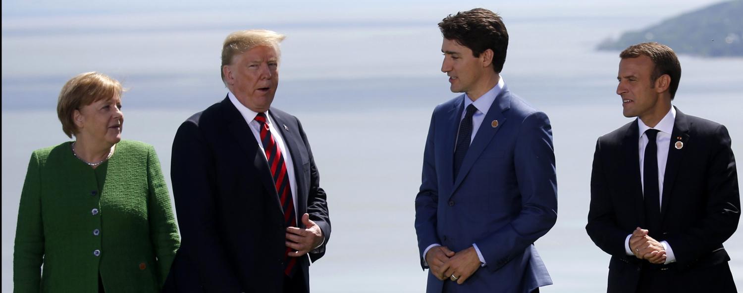 Germany's Chancellor Angela Merkel, U.S. President Donald Trump, Canada's Prime Minister Justin Trudeau and France's President Emmanuel Macron gather for a family photo with the other leaders of the G-7 summit in the Charlevoix city of La Malbaie, Quebec, Canada, June 8, 2018. REUTERS/Leah Millis - HP1EE681G6T1K