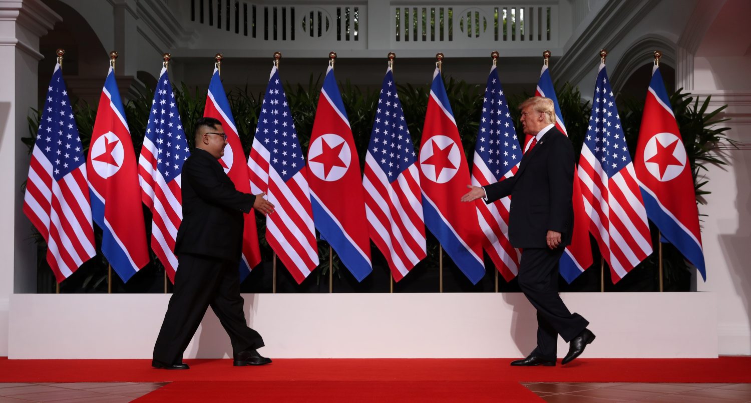 U.S. President Donald Trump and North Korean leader Kim Jong-un prepare to shake hands at the Capella Hotel in Singapore.