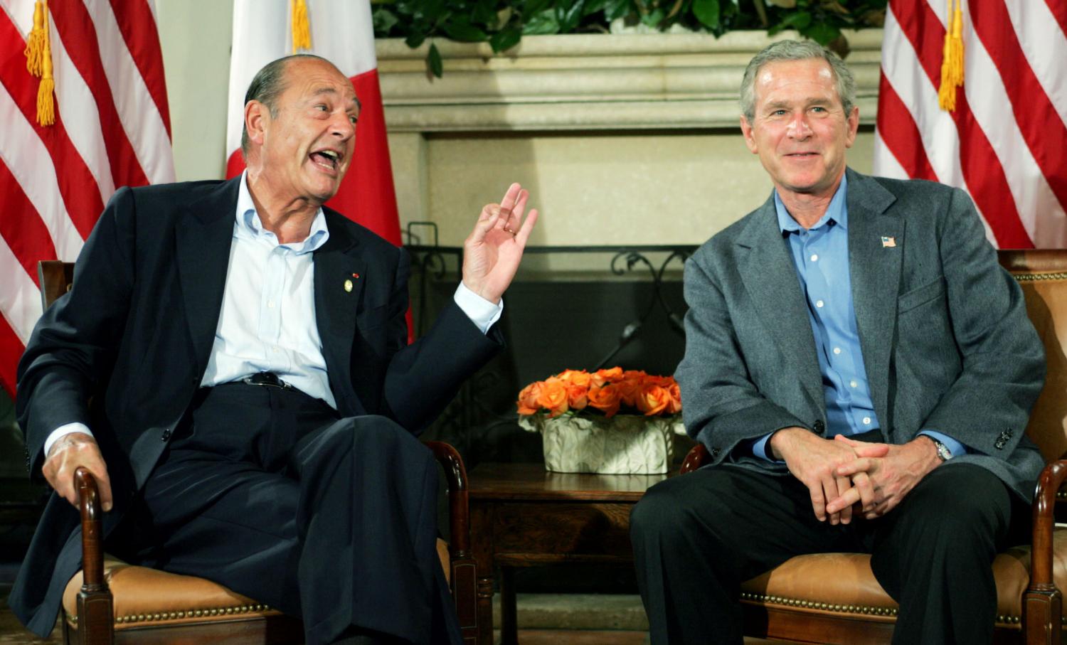 French President Jacques Chirac (L) poses with U.S. President George W. Bush prior to their bilateral meeting at the G8 summit, in Sea Island, Georgia June 10, 2004. [The United States and its seven fellow Group of Eight members agreed a common approach to reform in the Middle East on Wednesday but promptly ran into differences over a role for NATO in Iraq.] - PBEAHUOIDBJ