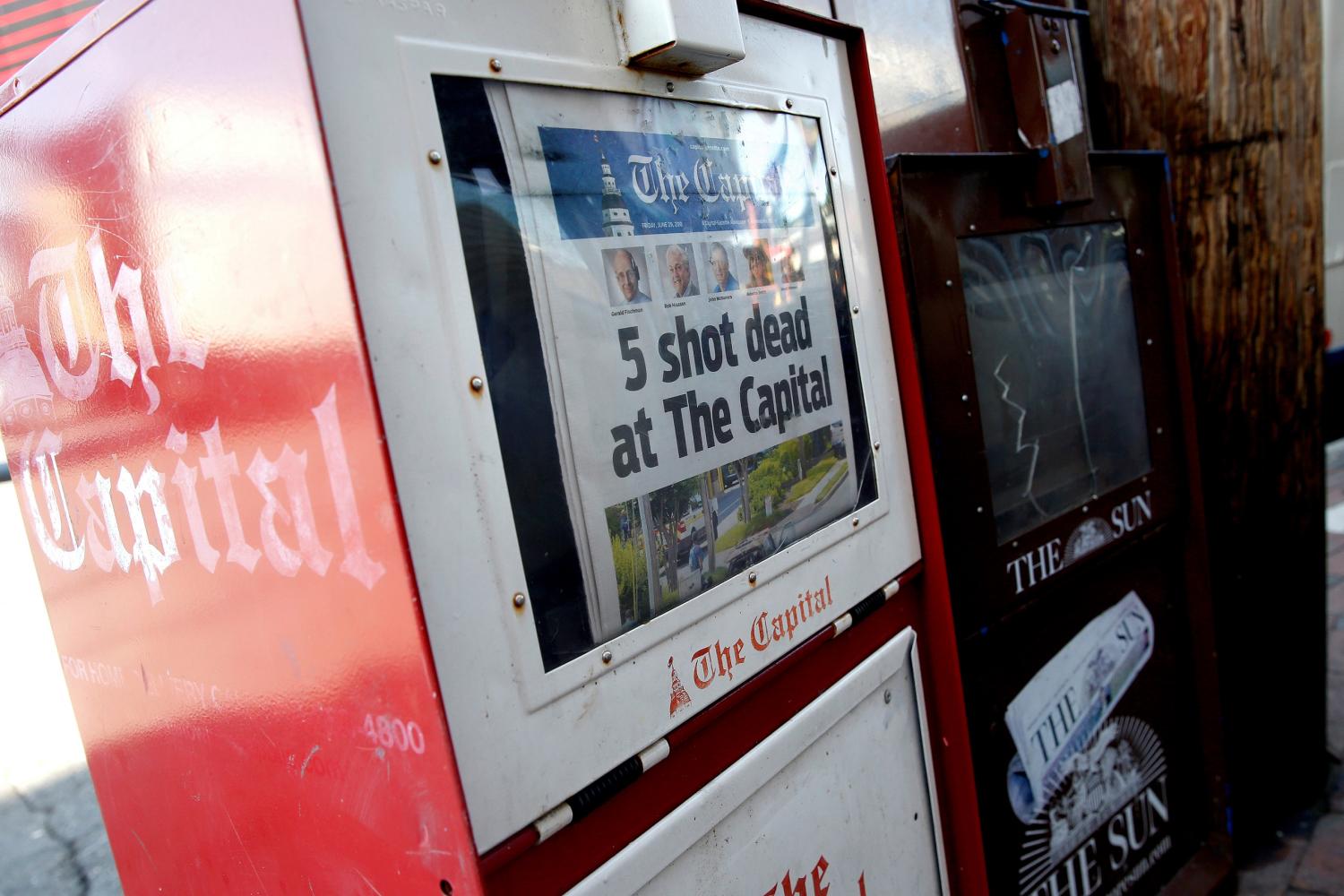 A copy of the Capital Gazette is displayed in a newspaper box the day after a gunman killed five people and injuring several others at the publication's offices in Annapolis, Maryland, U.S., June 29, 2018. REUTERS/Joshua Roberts - RC1B67B7C9D0
