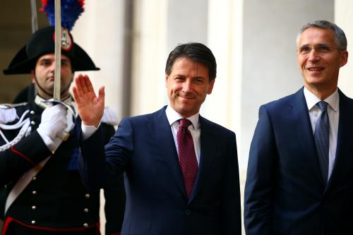 Italy's Prime Minister Giuseppe Conte waves as he arrives with NATO Secretary-General Jens Stoltenberg at Chigi palace in Rome, Italy, June 11, 2018.  REUTERS/Tony Gentile - RC1AFEEA6610