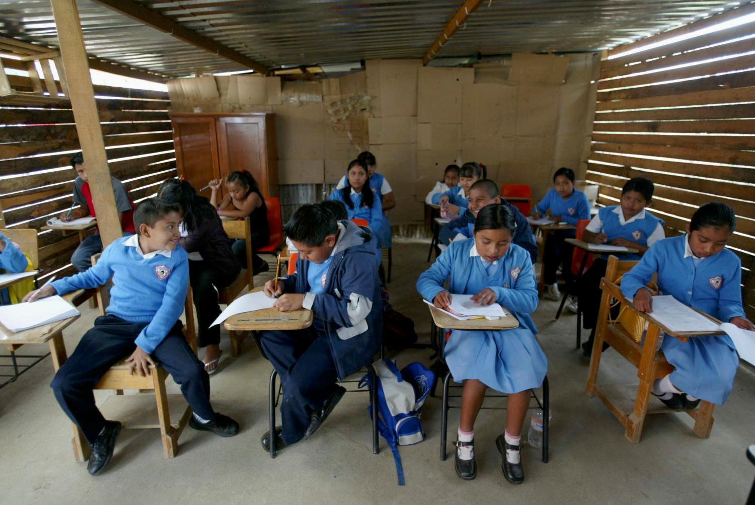 Children sit in their classroom on their first day of school in Oaxaca's capital