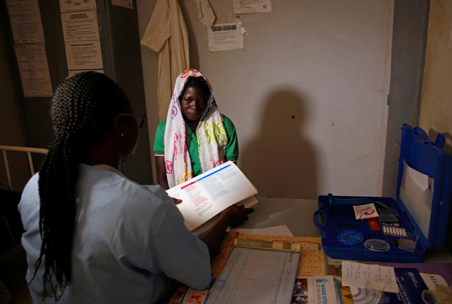 A nurse chats with a woman