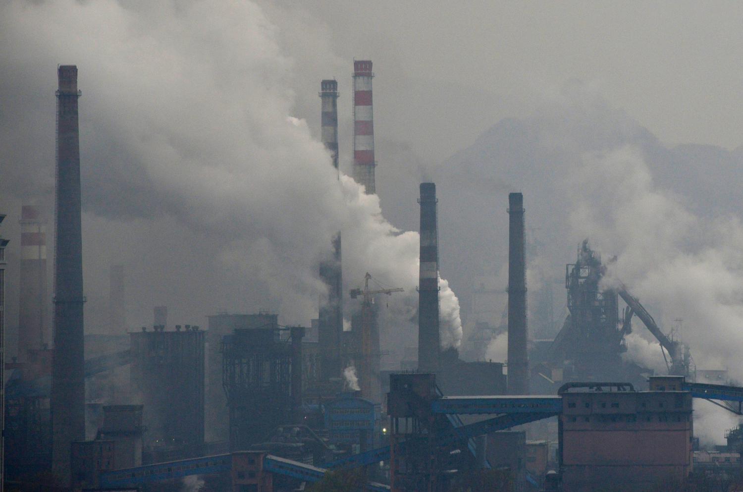 Smoke rises from chimneys and facilities of steel plants on a hazy day in Benxi, Liaoning province November 3, 2013. A chronic shortage of natural gas is hurting China's plan to move away from burning coal to heat homes and offices, raising the prospect of more choking air pollution this winter and beyond. The problem is worst in northern China, where air pollution mainly caused by decades of reliance on coal has lowered life expectancy by an estimated 5.5 years compared to the south, Chinese and international researchers said in July. Picture taken November 3, 2013. REUTERS/Stringer (CHINA - Tags: ENVIRONMENT ENERGY) CHINA OUT. NO COMMERCIAL OR EDITORIAL SALES IN CHINA - GM1E9B40RS301