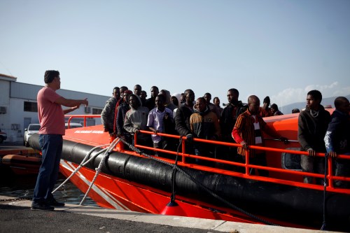 Migrants, part of a group intercepted aboard dinghies off the coast in the Mediterranean Sea, stand on a rescue boat upon arrival at the port of Motril, southern Spain, June 25, 2018. REUTERS/Jon Nazca - RC15D3945C00