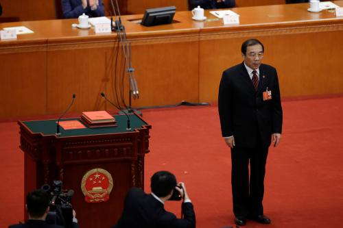 Newly elected head of the National Supervision Commission Yang Xiaodu stands after he takes the oath to the Constitution at the sixth plenary session of the National People's Congress (NPC) at the Great Hall of the People in Beijing, China March 18, 2018.