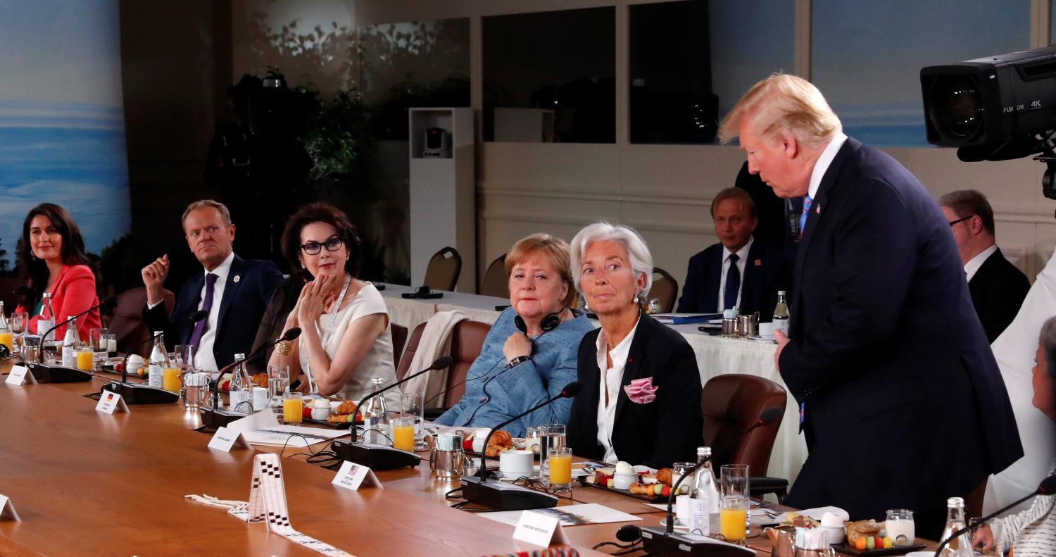Christine Lagarde, the Managing Director of the International Monetary Fund, German Chancellor Angela Merkel, Dayle Haddon and other leaders react as U.S. President Donald Trump shows up late to the Gender Equality Advisory Council breakfast working during the G-7 summit in the Charlevoix city of La Malbaie, Quebec, Canada, June 9, 2018. REUTERS/Leah Millis - RC152CE02870
