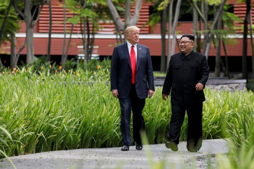 U.S. President Donald Trump and North Korea's leader Kim Jong Un walk together before their working lunch during their summit at the Capella Hotel on the resort island of Sentosa, Singapore June 12, 2018. Picture taken June 12, 2018. REUTERS/Jonathan Ernst - RC116285B8A0