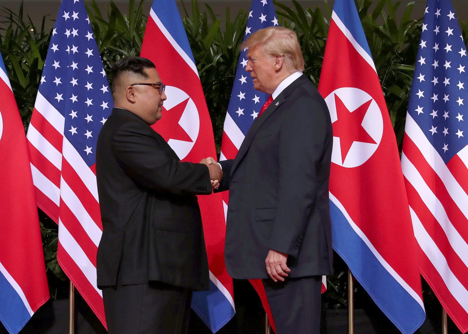 U.S. President Donald Trump shakes hands with North Korean leader Kim Jong Un at the Capella Hotel on Sentosa island in Singapore June 12, 2018. REUTERS/Jonathan Ernst - RC1BF3A56C10