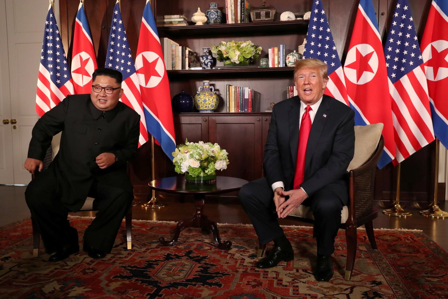 U.S. President Donald Trump sits next to North Korea's leader Kim Jong Un before their bilateral meeting at the Capella Hotel on Sentosa island in Singapore June 12, 2018. REUTERS/Jonathan Ernst     TPX IMAGES OF THE DAY - RC1D123560A0