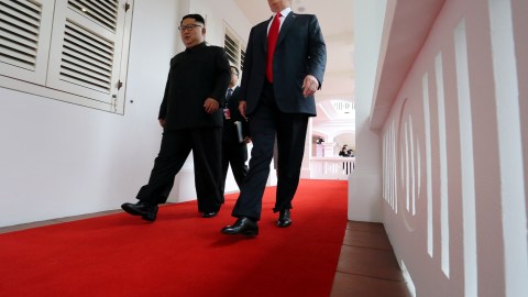 U.S. President Donald Trump walks with North Korean leader Kim Jong Un at the Capella Hotel on Sentosa island in Singapore June 12, 2018. REUTERS/Jonathan Ernst - RC13FC8C39E0