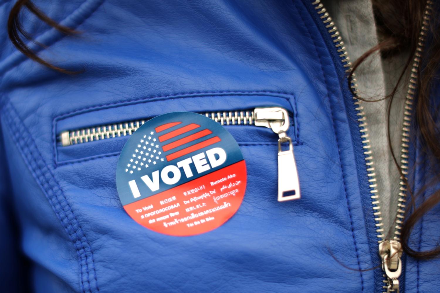 A woman wears a sticker in multiple languages after voting in the primary election at a polling station in Venice, Los Angeles, California, U.S. June 5, 2018. REUTERS/Lucy Nicholson - RC1BF5D43BD0