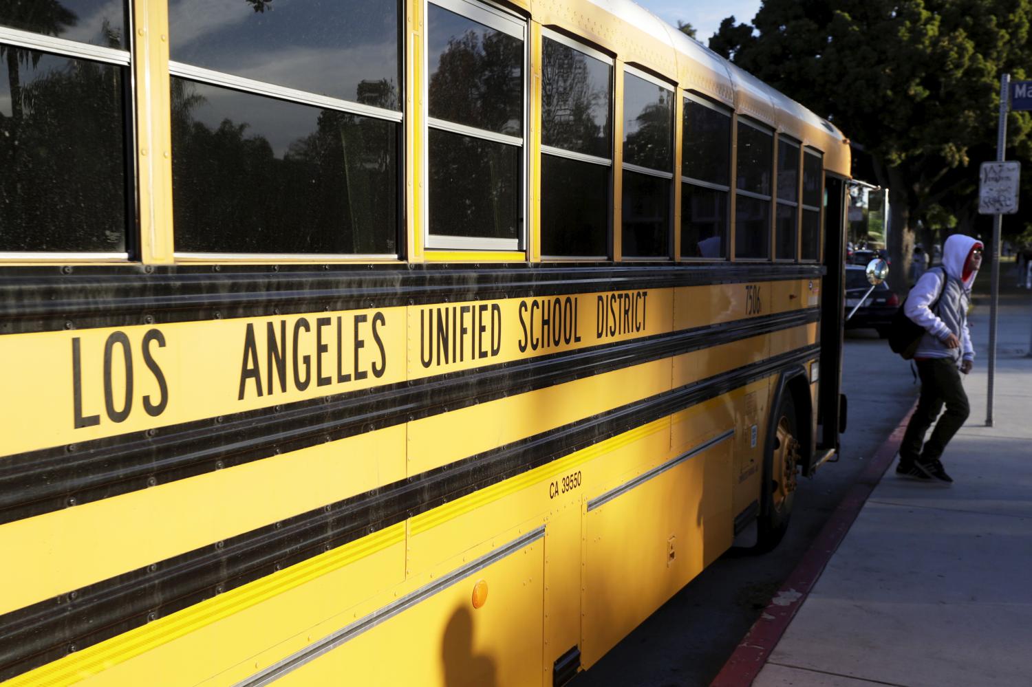 A student exits a bus as he arrives at Venice High School in Los Angeles, California December 16, 2015. Classes resume today in Los Angeles, the second largest school district in the United States,  after they were closed on Tuesday after officials reported receiving an unspecified threat to the district and ordered a search of all schools in the city. REUTERS/Jonathan Alcorn - GF10000267926