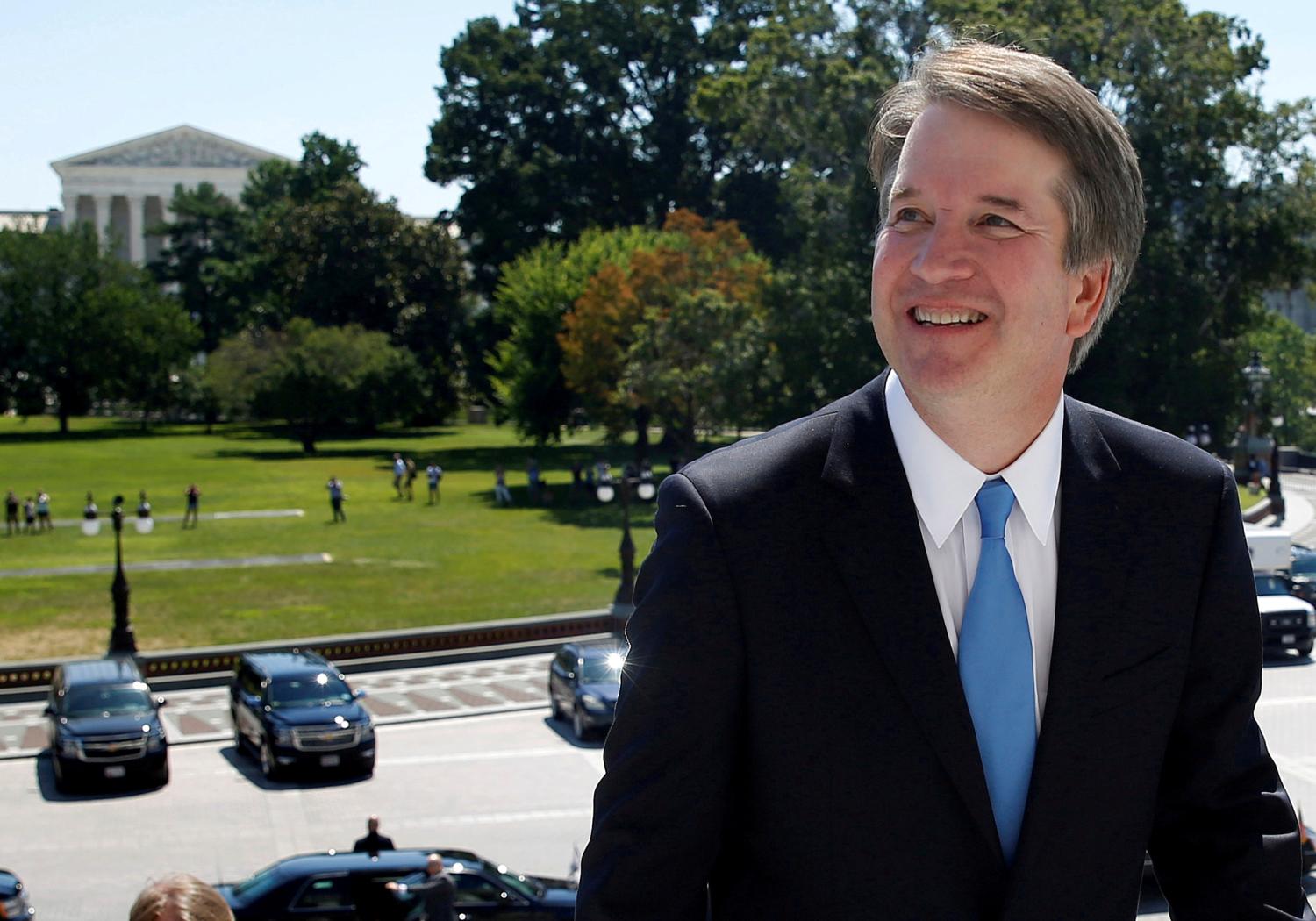 FILE PHOTO:    With the U.S. Supreme Court building in the background, Supreme Court nominee judge Brett Kavanaugh arrives prior to meeting with Senate Majority Leader Mitch McConnell on Capitol Hill in Washington, U.S., July 10, 2018. REUTERS/Joshua Roberts/File Photo - RC193B83C020