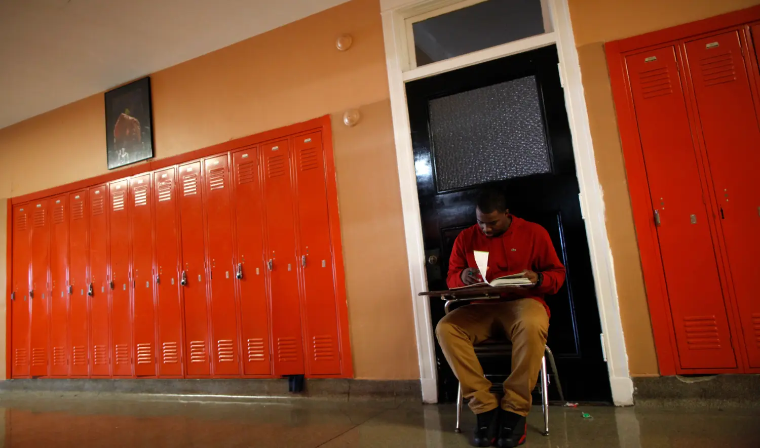 A student take a test in the hallway outside the classroom