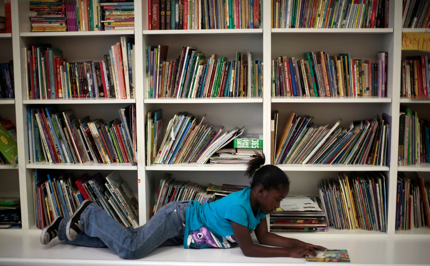 Iana Williams, 8, reads a book