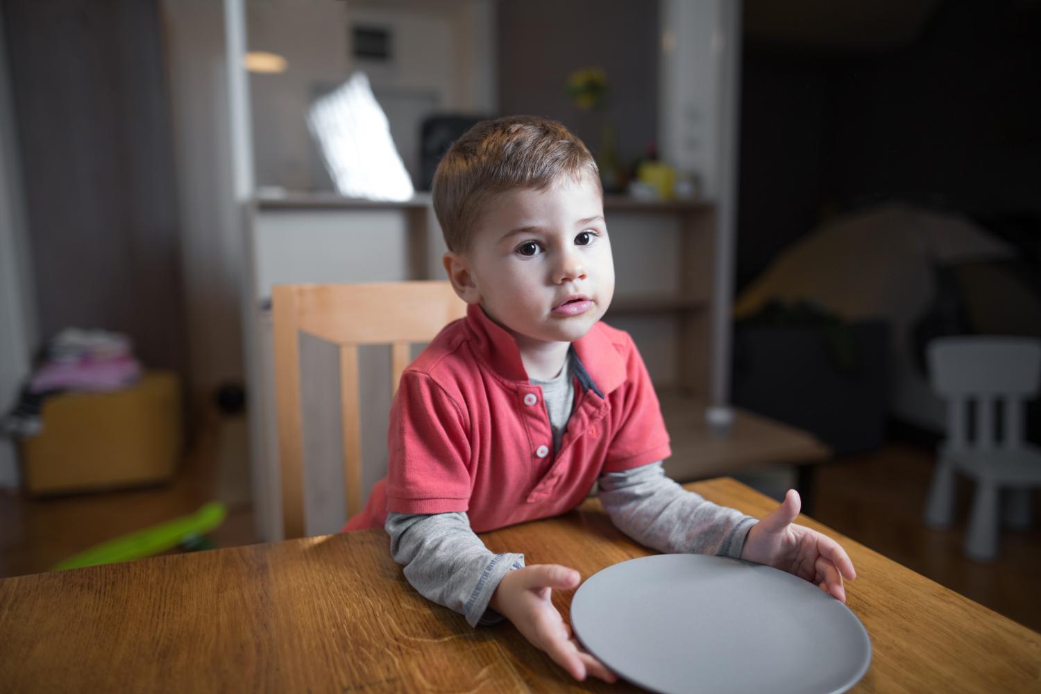 Cute little hungry boy waiting for his dinner