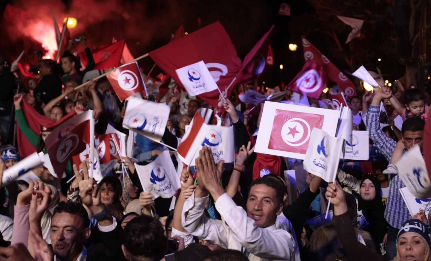 Supporters of the Islamist Ennahda movement wave party flags during a campaign event in Tunis October 24, 2014. Tunisia will hold parliamentary elections on October 26 and a presidential ballot in November. REUTERS/Zoubeir Souissi