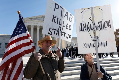 Protesters gather outside the Supreme Court, as the justices will hear arguments over whether a federal administrative process frequently used by high technology companies to invalidate patents they are accused of infringing violates the U.S. Constitution, in Washington, U.S., November 27, 2017. REUTERS/Yuri Gripas - RC1587F1F1B0