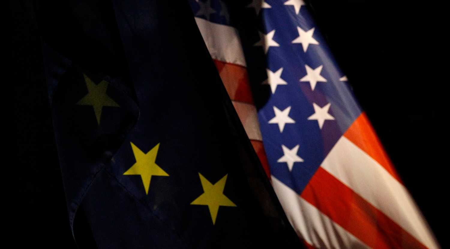 An EU flag and an U.S. flag are pictured in front of the German Finance Ministry before a meeting between German Finance Minister Wolfgang Schaeuble and U.S.Treasury Secretary Timothy Geithner in Berlin December 6, 2011. REUTERS/Tobias Schwarz (GERMANY - Tags: POLITICS BUSINESS) - BM2E7C61DV401