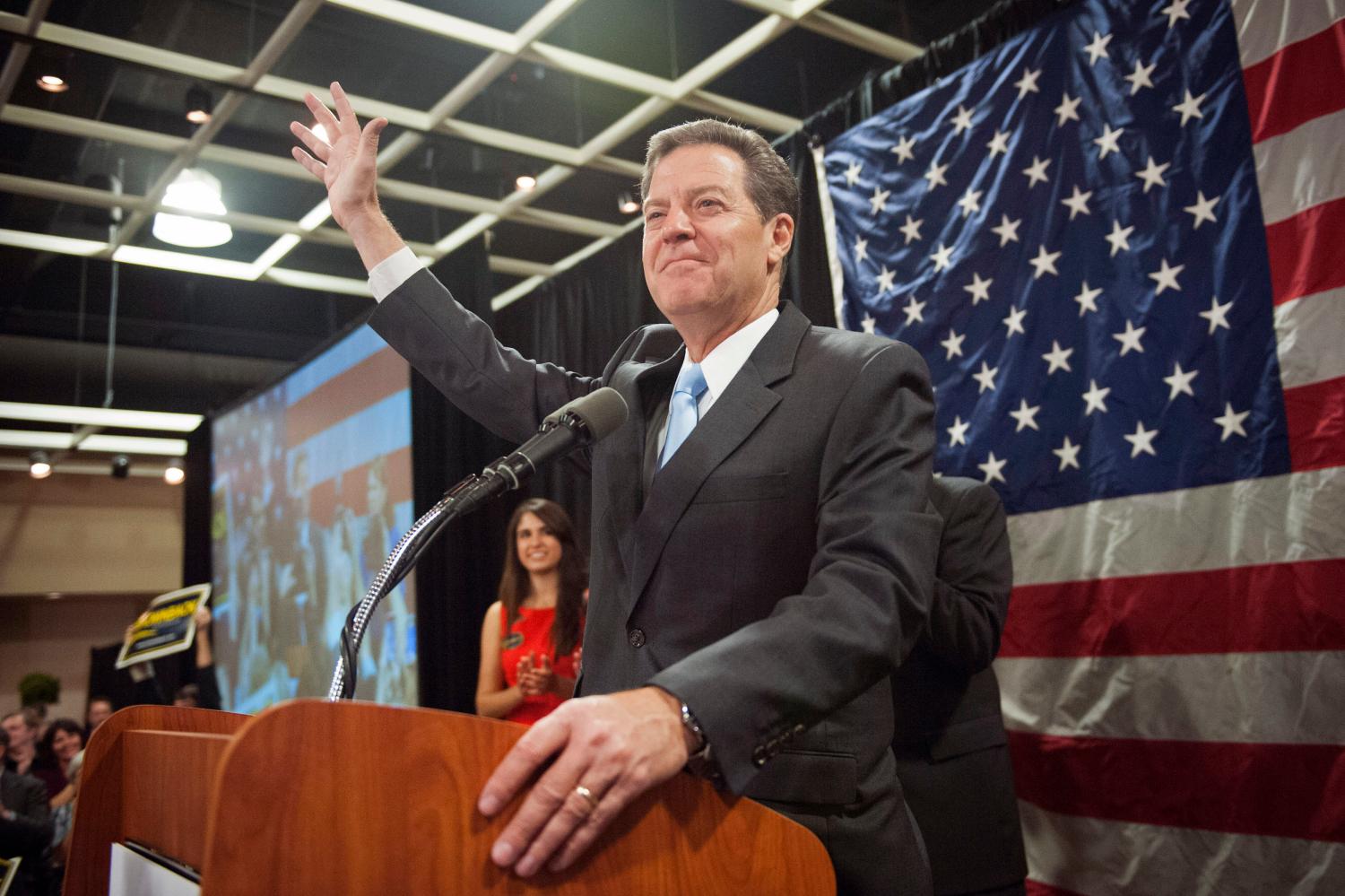 Republican Kansas Governor Sam Brownback speaks to supporters after winning re-election in the U.S. midterm elections in Topeka, Kansas, November 4, 2014. Brownback, a former U.S. senator and presidential candidate, won re-election despite a bruising campaign that focused on the fiscal problems that followed his tax cuts. REUTERS/Mark Kauzlarich (UNITED STATES - Tags: POLITICS ELECTIONS) - GM1EAB512RY01