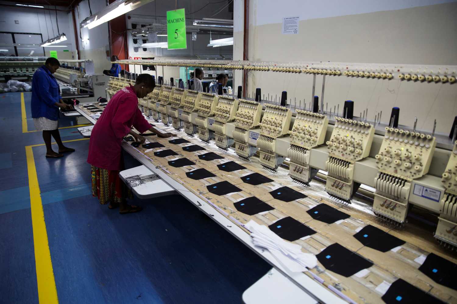 Employees work on the manufacturing line at the United Aryan Export Processing Zone textile factory in Nairobi, Kenya April 13, 2017. Picture taken April 13, 2017. REUTERS/Baz Ratner - RC116416CF10