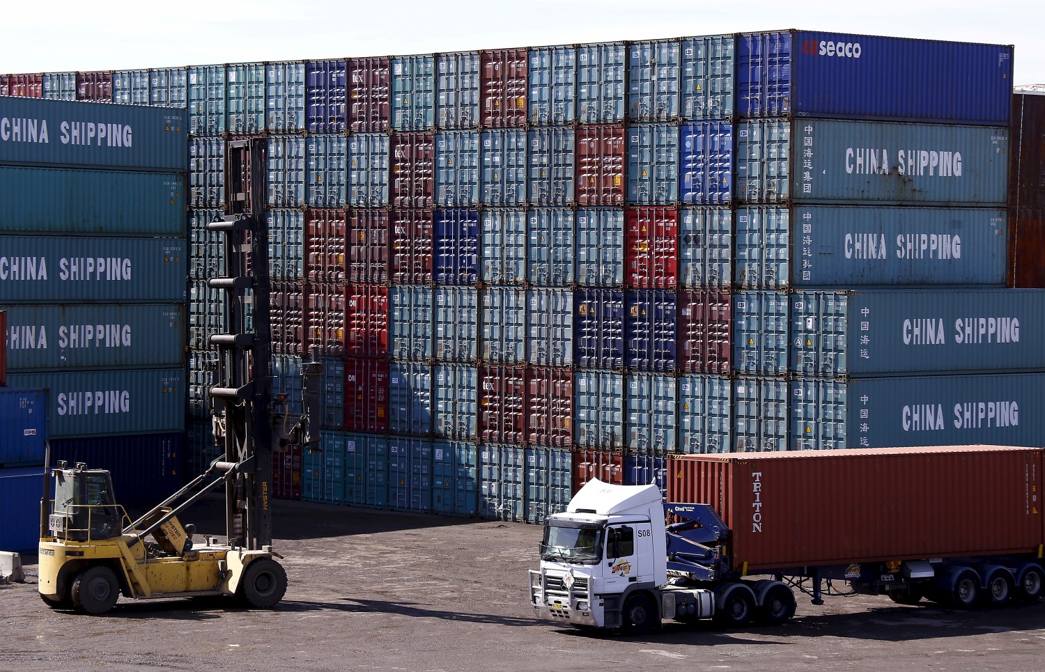 A worker driving a forklift stacks containers in a yard at Port Botany's container handling facility located in Sydney, Australia, March 2, 2016. Picture taken March 2, 2016. REUTERS/David Gray - GF10000371752