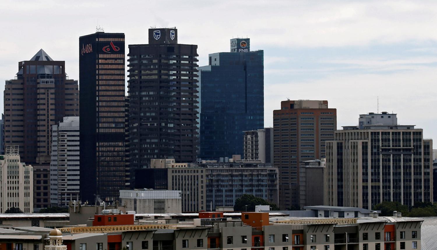 The buildings with the logos of three of South Africa's biggest banks, ABSA, Standard Bank and First National Bank (FNB) are seen against the city skyline in Cape Town, South Africa, August 30, 2017. Picture taken August 30, 2017. REUTERS/Mike Hutchings - RC199A8F64C0