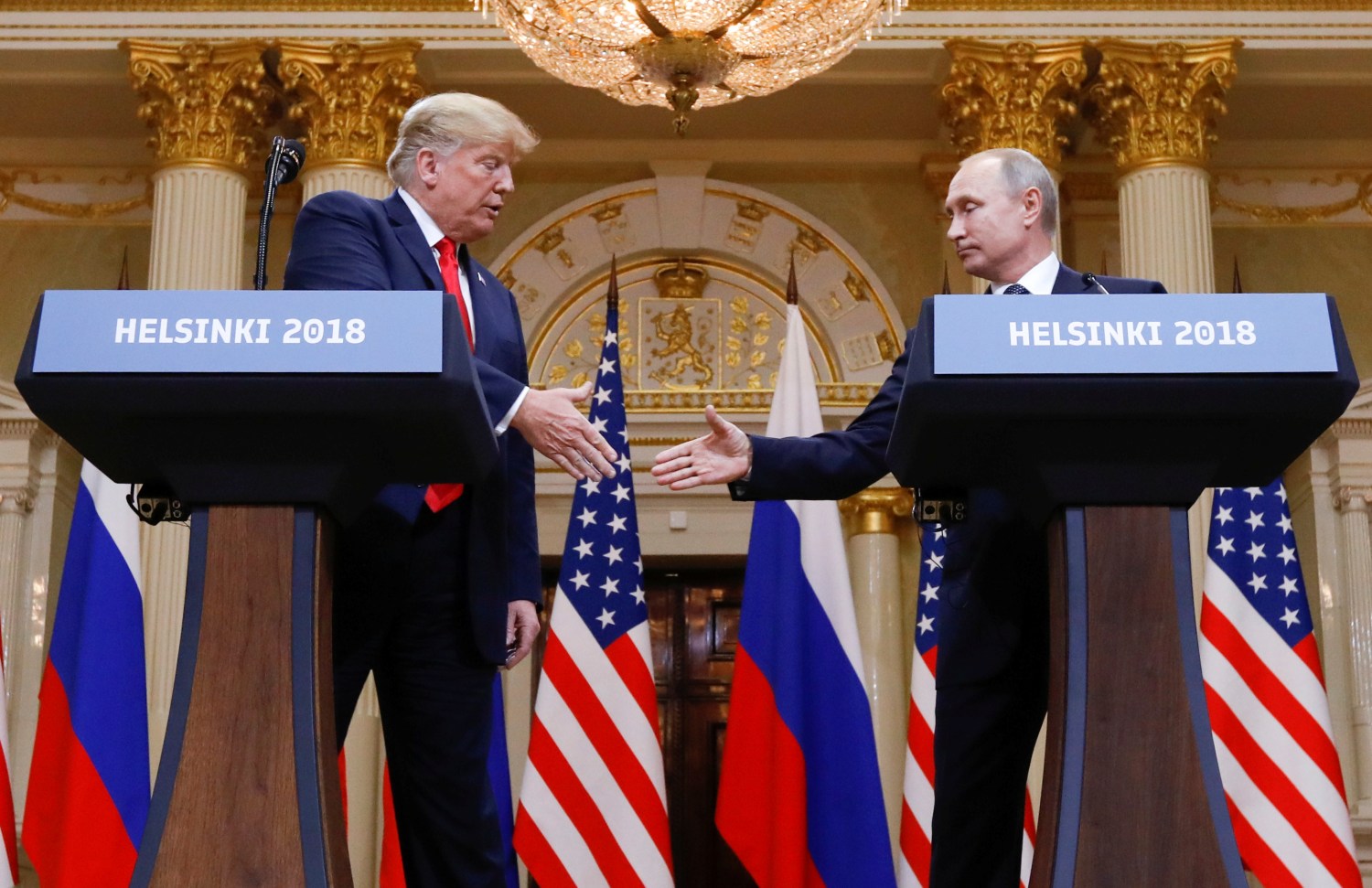 U.S. President Donald Trump and Russia's President Vladimir Putin shake hands during a joint news conference after their meeting in Helsinki, Finland, July 16, 2018. REUTERS/Kevin Lamarque - RC145902DE10