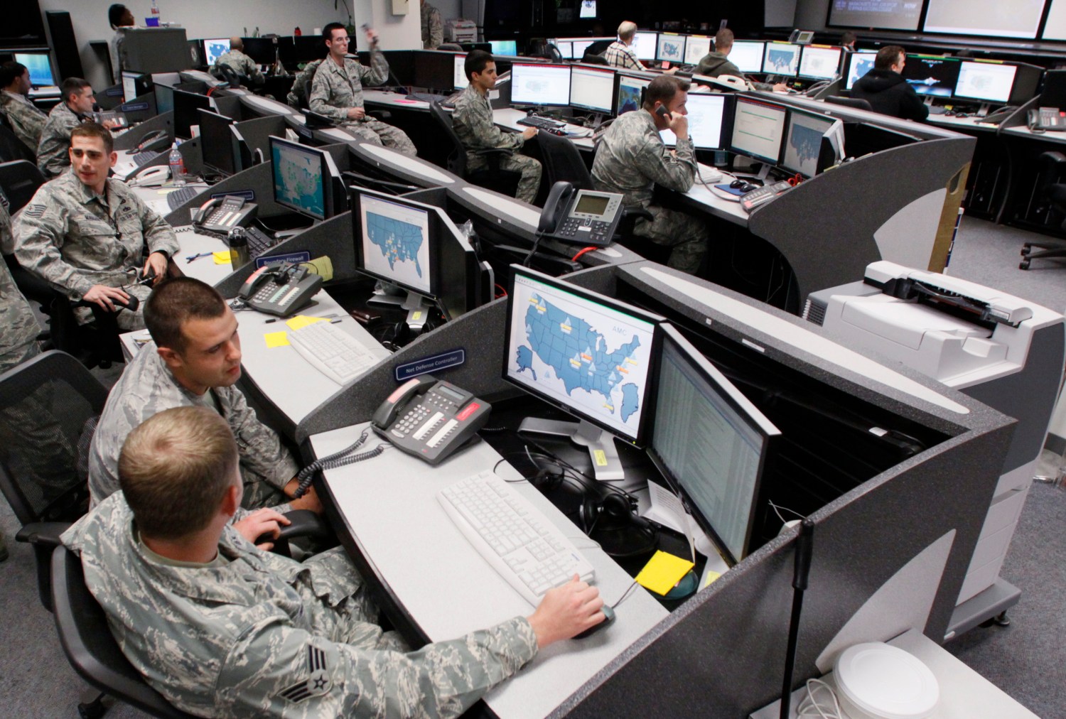 Personnel work at the Air Force Space Command Network Operations & Security Center at Peterson Air Force Base in Colorado Springs, Colorado July 20, 2010. U.S. national security planners are proposing that the 21st century's critical infrastructure -- power grids, communications, water utilities, financial networks -- be similarly shielded from cyber marauders and other foes. The ramparts would be virtual, their perimeters policed by the Pentagon and backed by digital weapons capable of circling the globe in milliseconds to knock out targets.  To match Special Report  USA-CYBERWAR/          REUTERS/Rick Wilking (UNITED STATES - Tags: MILITARY SCI TECH POLITICS) - GM1E6A51SA301