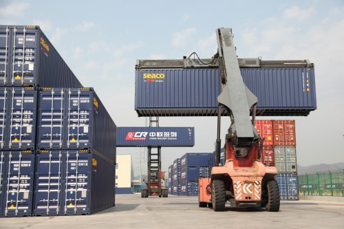 Container handlers transport containers at the railway port in Yiwu, Zhejiang province, China April 15, 2017. Picture taken April 15, 2017. To match Insight CHINA-EUROPE/SILKROAD  REUTERS/Stringer  ATTENTION EDITORS - THIS IMAGE WAS PROVIDED BY A THIRD PARTY. CHINA OUT. - RC182DBB0320