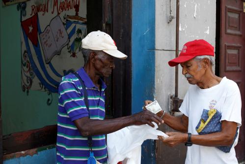 A man buys plastic bags outside a subsidized state store, or "bodega", where Cubans can buy basic products with a ration book they receive annually from the government, in Havana, Cuba June 16, 2017.  REUTERS/Stringer - RC1713682E50
