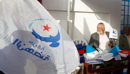 A supporter of the Islamist Ennahda Party holds a party flag during a municipal elections campaign in Tunis, Tunisia April 28, 2018. Picture taken April 28, 2018. REUTERS/Zoubeir Souissi - RC1319B67DE0