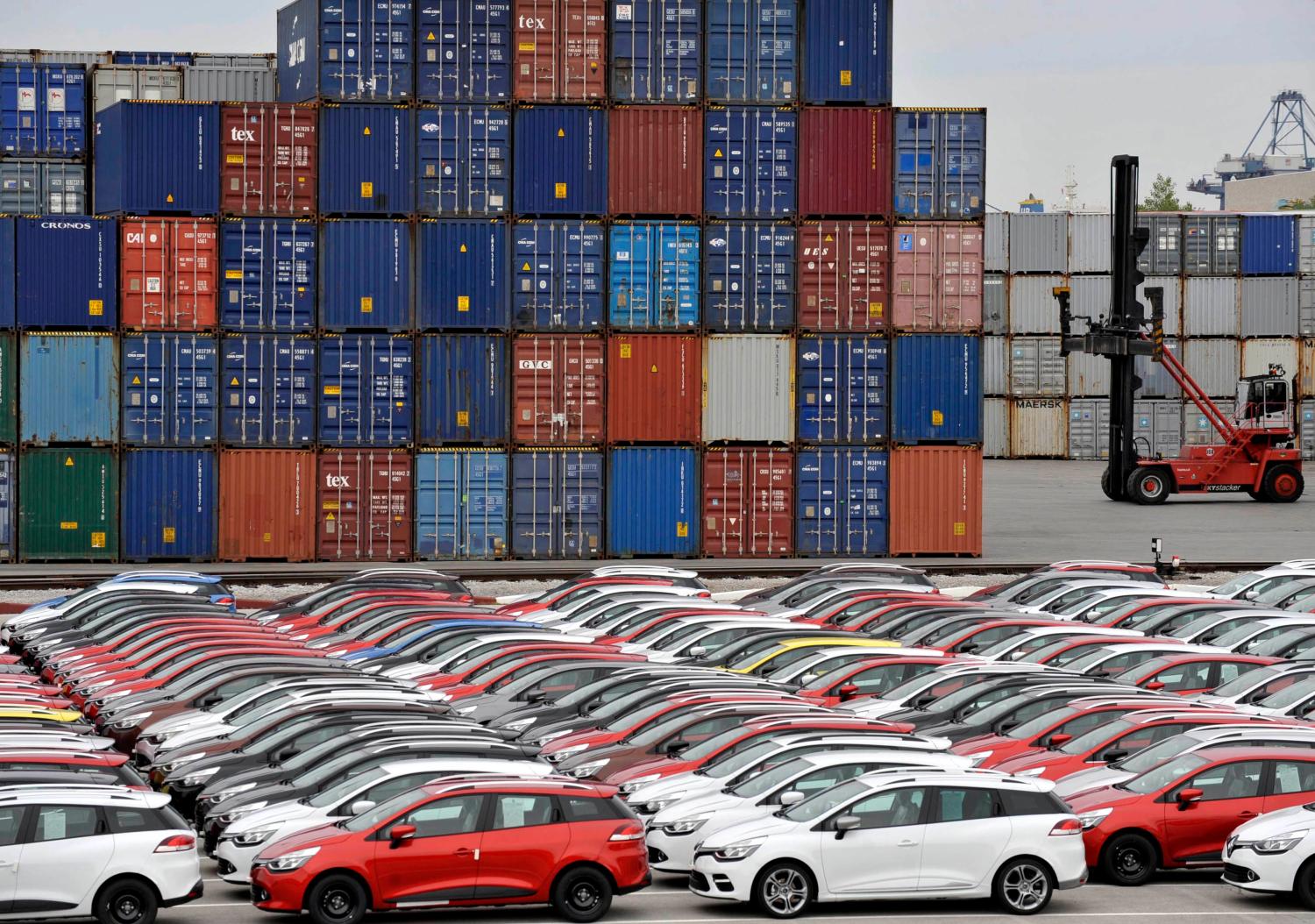 Renault cars produced in Turkey and awaiting export throughout Europe, are lined-up in front of ship containers in the port of Koper October 14, 2013. Automotive industry association ACEA said October 16, 2013, that new car registrations in Europe climbed 5.5 percent to 1.19 million vehicles in September, only the third month a gain was recorded in the past two years. But within the European Union, the level of demand was the second lowest on record for the month of September since it began tabulating results for the 27 member states in 2003. Picture taken October 14. REUTERS/Srdjan Zivulovic (SLOVENIA - Tags: TRANSPORT BUSINESS) - BM2E9AF0WYI01