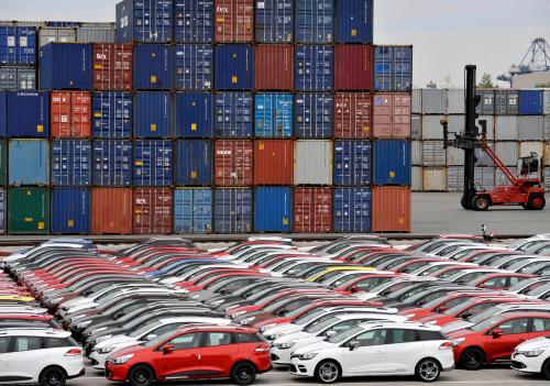 Renault cars produced in Turkey and awaiting export throughout Europe, are lined-up in front of ship containers in the port of Koper October 14, 2013. Automotive industry association ACEA said October 16, 2013, that new car registrations in Europe climbed 5.5 percent to 1.19 million vehicles in September, only the third month a gain was recorded in the past two years. But within the European Union, the level of demand was the second lowest on record for the month of September since it began tabulating results for the 27 member states in 2003. Picture taken October 14. REUTERS/Srdjan Zivulovic (SLOVENIA - Tags: TRANSPORT BUSINESS) - BM2E9AF0WYI01