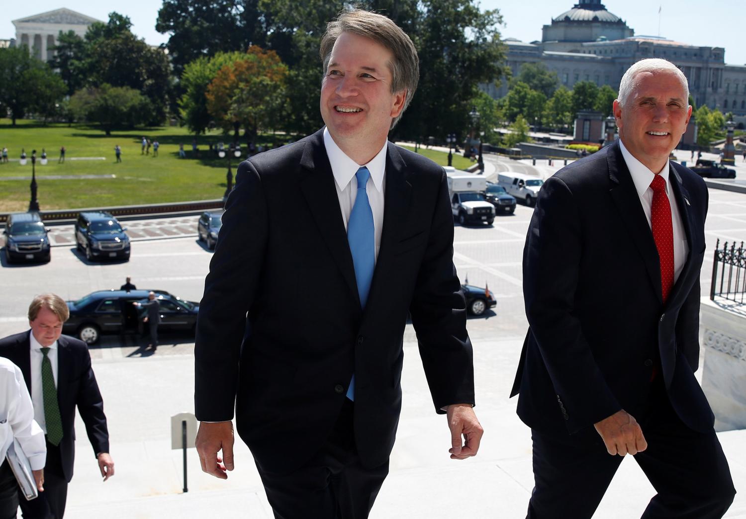 With the U.S. Supreme Court building in the background, Supreme Court nominee judge Brett Kavanaugh arrives with U.S. Vice President Mike Pence prior to meeting with Senate Majority Leader Mitch McConnell on Capitol Hill in Washington, U.S., July 10, 2018. REUTERS/Joshua Roberts - RC1165F1B5C0