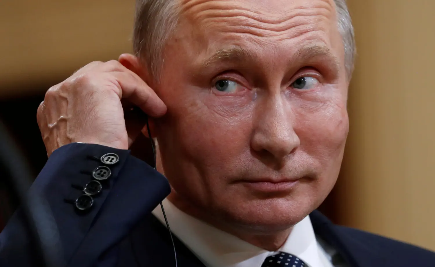 Russian President Vladimir Putin listens as U.S. President Donald Trump speaks during their news conference in Helsinki, Finland July 16, 2018.  REUTERS/Kevin Lamarque - RC188258ED00