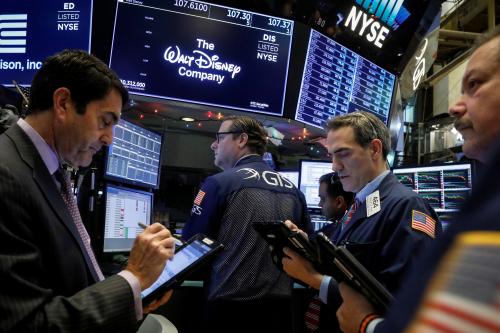 Traders work at the post where Walt Disney Co. stock is traded on the floor of the New York Stock Exchange (NYSE) in New York, U.S., December 14, 2017. REUTERS/Brendan McDermid - RC1889B0E830