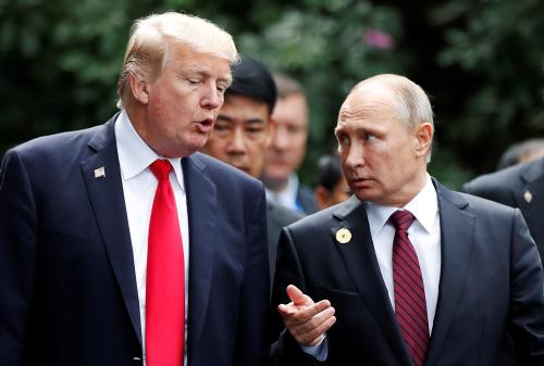 U.S. President Donald Trump and Russia's President Vladimir Putin talk during the family photo session at the APEC Summit in Danang, Vietnam November 11, 2017. REUTERS/Jorge Silva - RC1B1EDB0E40