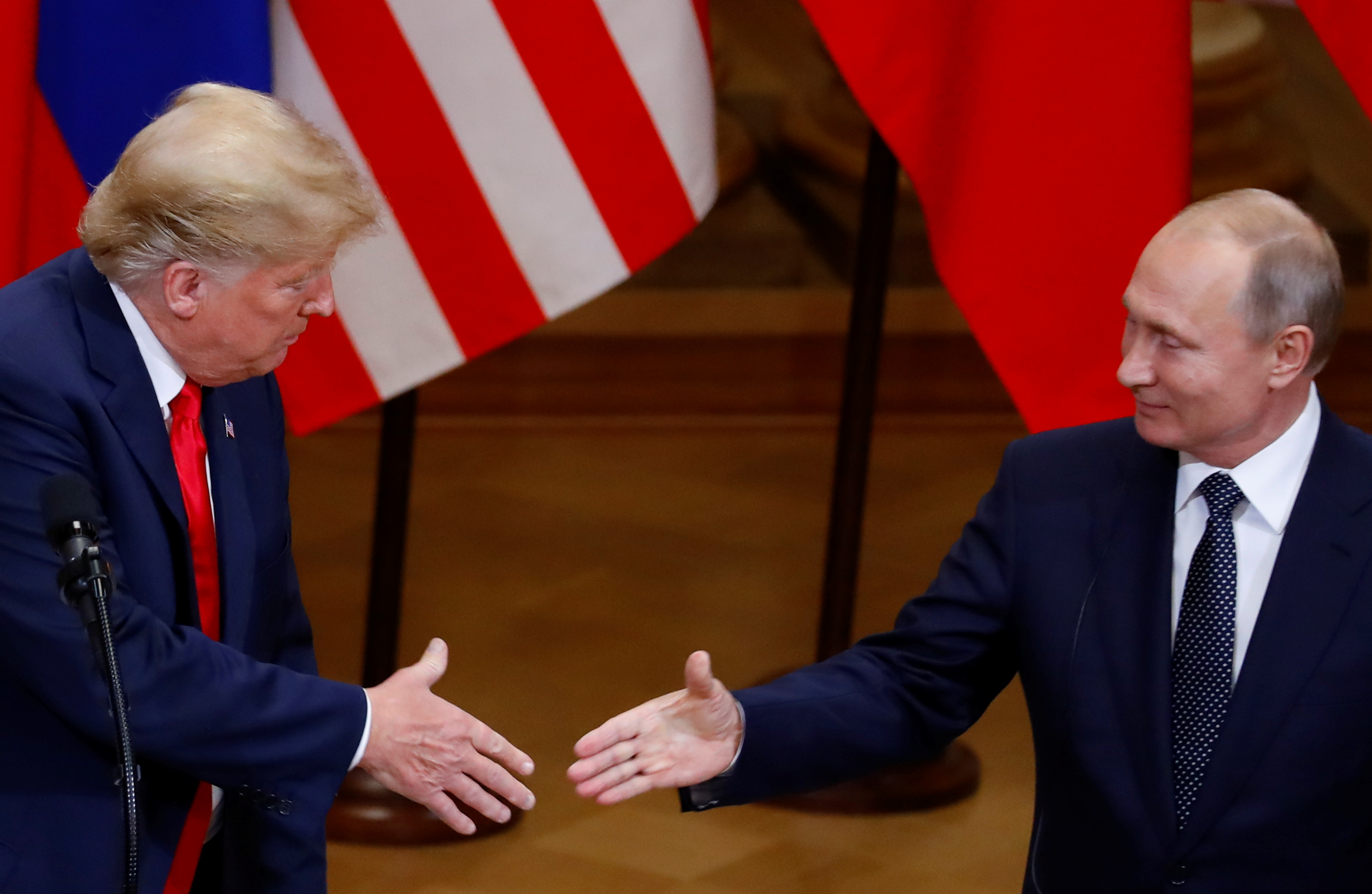 U.S. President Donald Trump and Russian President Vladimir Putin shake hands as they hold a joint news conference after their meeting in Helsinki, Finland, July 16, 2018. REUTERS/Leonhard Foeger - RC12B198BCE0