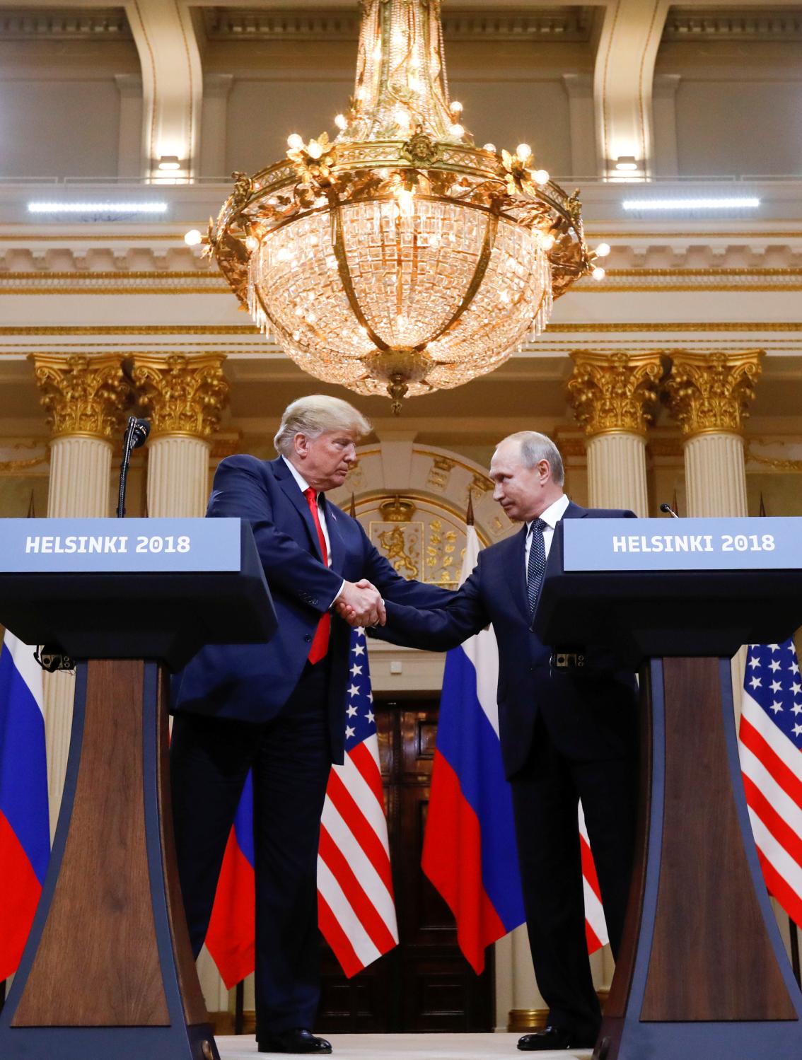 U.S. President Donald Trump and Russia's President Vladimir Putin shake hands during a joint news conference after their meeting in Helsinki, Finland, July 16, 2018. REUTERS/Kevin Lamarque - RC181F828BC0