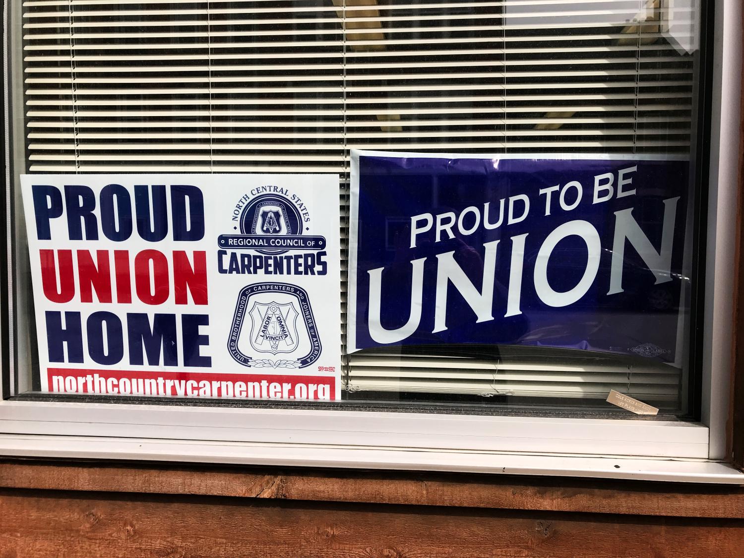 Union signs adorn the windows of a home in Dubuque, Iowa, U.S. March 29, 2018. Picture taken March 29. 2018. REUTERS/Tim Reid - RC11E756E7F0