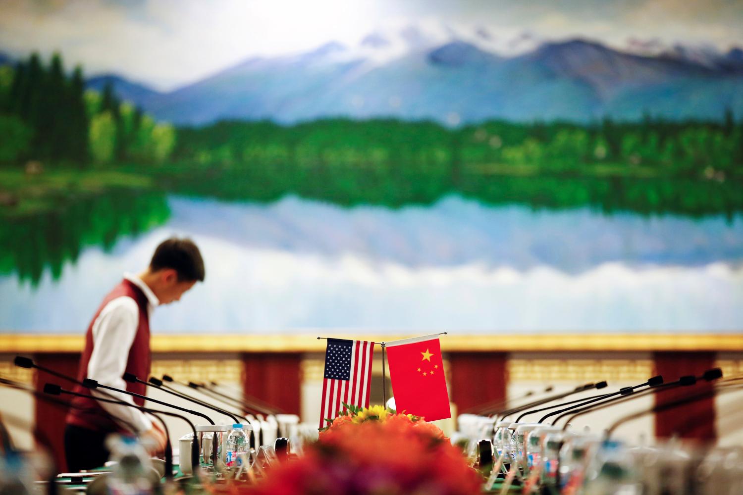 A staff member prepares the table before talks during the first China-US judicial dialogue at the Rui'an hotel in Beijing, China, August 3, 2016. REUTERS/Thomas Peter - S1BETTHMUQAA